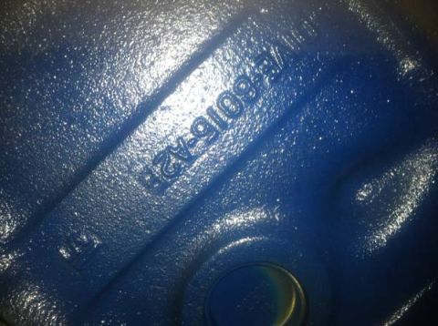 1978 Ford Bronco - A close-up view of a blue-painted metal part with embossed lettering is shown.