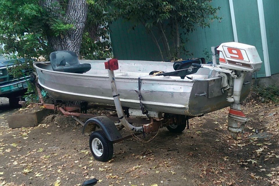 Aluminum jon boat on trailer with outboard motor and trolling motor