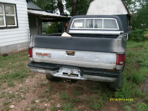 1979 GMC C/K Pickup - This 1979 GMC C/K Pickup truck is seen from the rear, its distinctive GMC badging and chrome bumper.