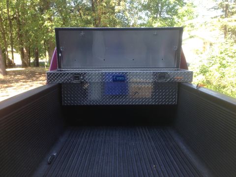 1992 Ford F-150 - A diamond plate toolbox with the UWS logo is mounted in the bed of a pickup truck.