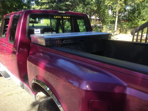 1992 Ford F-150 - This 1992 Ford F-150 pickup features a diamond plate toolbox mounted in the bed, visible from the side.