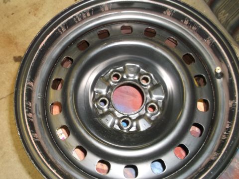 1971 Ford Ranchero - Close-up of a steel wheel rim, showing its construction and lug nut pattern.