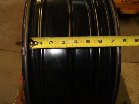 1971 Ford Ranchero - A tape measure is used to measure the width of a black rim.