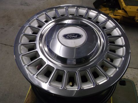 1971 Ford Ranchero - A close-up view of a Ford hubcap, showing its metallic finish and branded center emblem.