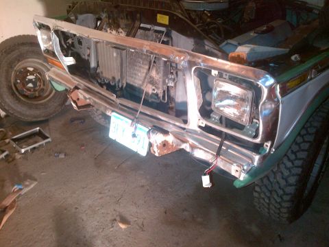 1978 Ford Bronco - The front of a truck is disassembled, revealing the radiator and internal components behind the grille area.