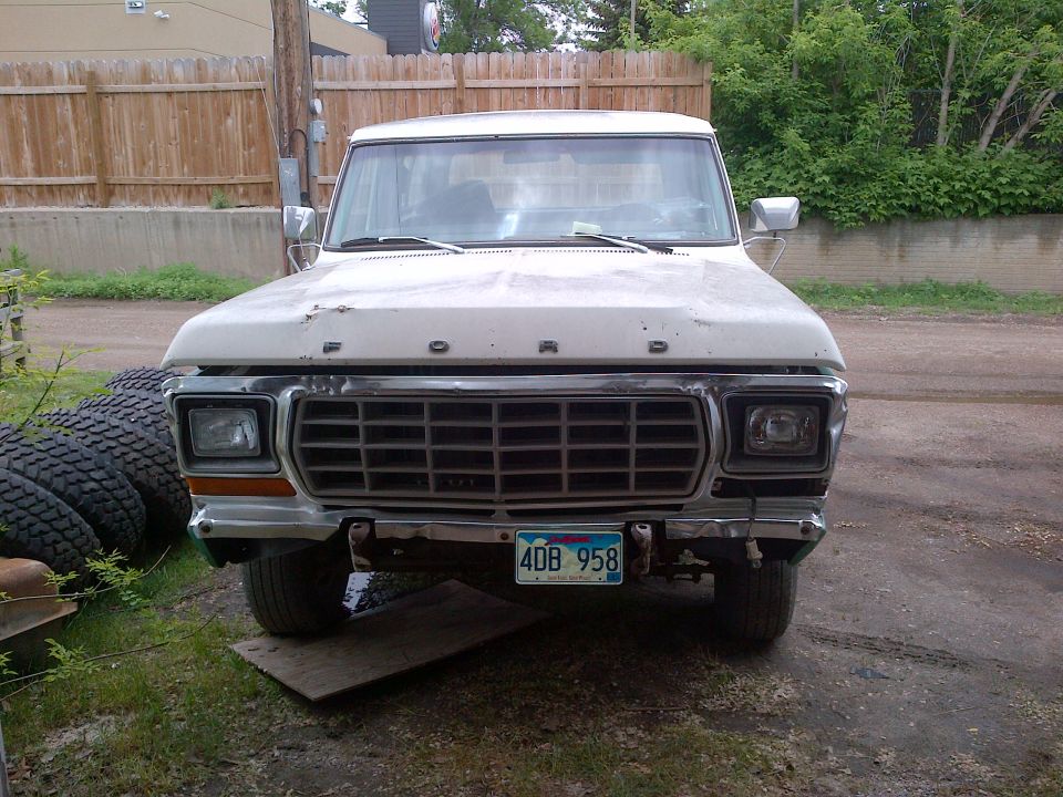 White 1978 Ford Bronco front view, grille and headlights visible, license plate 4DB 958