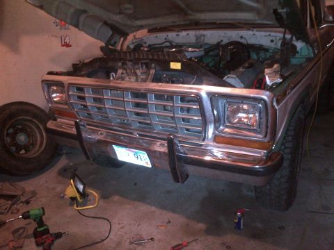 1978 Ford Bronco - Front view of a 1978 Ford Bronco with its hood open, revealing the engine bay and grille.