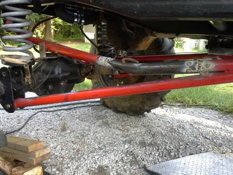Close-up of red suspension arms and differential on a vehicle