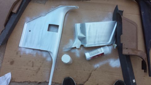 1990 Ford Bronco - Interior trim pieces are laid out on a surface, appearing to be prepped for painting.