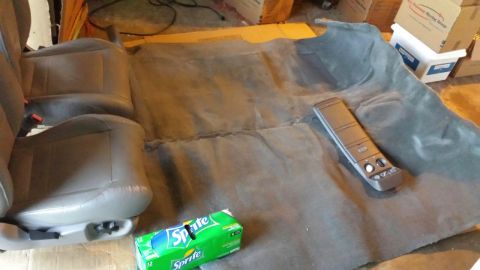 1990 Ford Bronco - Interior carpet and seats are laid out, with a Sprite box and a center console visible.