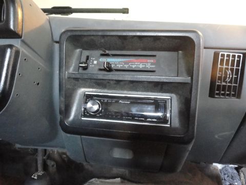 1990 Ford Bronco - The interior dashboard features an aftermarket Pioneer stereo system and climate controls.