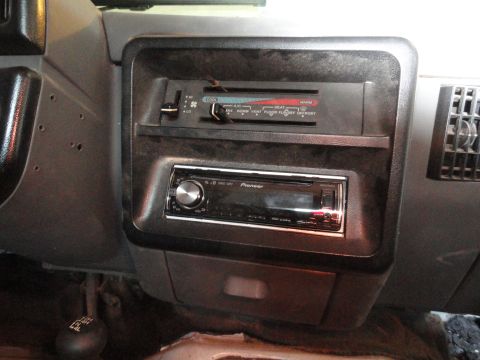 1990 Ford Bronco - Interior view of a vehicle's dashboard, a Pioneer stereo and climate controls.