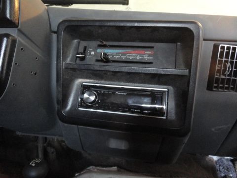 1990 Ford Bronco - The dashboard features an aftermarket stereo and climate controls, with a gear shifter in view.