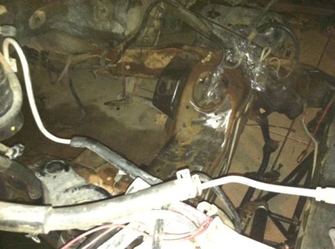 1995 Ford Bronco - Close-up view of engine bay components, including hoses and wiring, with visible rust and wear.