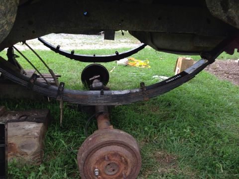 1979 Ford Bronco - Close-up view of leaf springs and rear axle assembly, showing a part number on the spring.