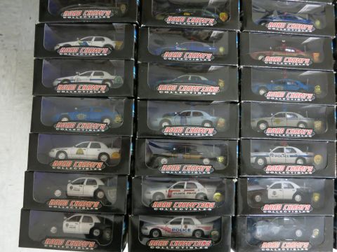 1991 Ford LTD Crown Victoria - Multiple boxed model police cars are displayed for sale, with 'Road Champs Collectibles' branding visible.