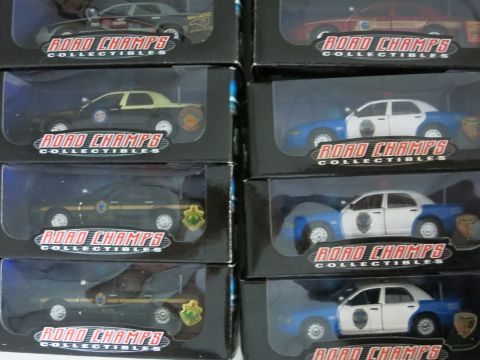 1991 Ford LTD Crown Victoria - Multiple police car models are displayed in their packaging, showing various liveries.