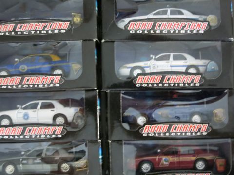 1991 Ford LTD Crown Victoria - Several boxed Road Champs collectible police car models are displayed, showing various liveries and vehicle types.