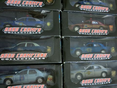 1991 Ford LTD Crown Victoria - Multiple Road Champs collectible police car models are displayed in their packaging.