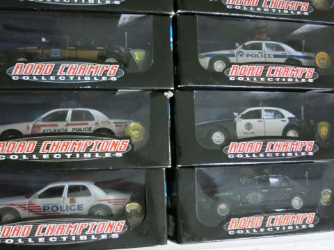 1991 Ford LTD Crown Victoria - Collection of Road Champs police car models displayed in their original packaging.