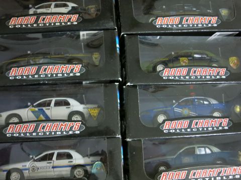 1991 Ford LTD Crown Victoria - Several model police cars are displayed in their packaging, with a 1991 Ford Crown Victoria LTD visible.