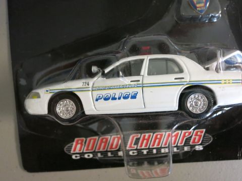 1991 Ford LTD Crown Victoria - This is a toy police car, likely a collectible, with visible text indicating it represents the City of Harrisburg police department.