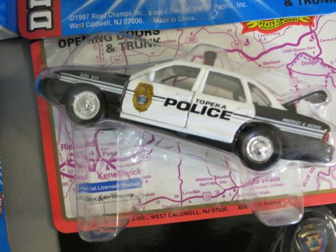 1991 Ford LTD Crown Victoria - Toy police car in packaging, labeled 'Topeka Police'.