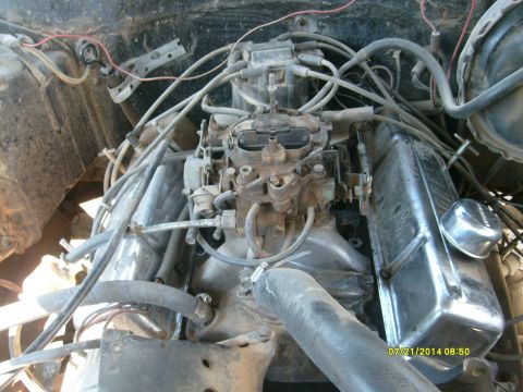 1979 GMC C/K Pickup - Engine bay detail showing the carburetor and associated wiring and hoses.