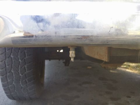 1996 Ford Bronco - A tire valve stem is visible hanging below the bumper of a vehicle.