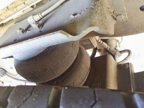 1996 Ford Bronco - Close-up of the air suspension system components on the underside of a vehicle.