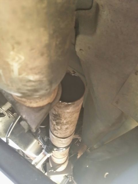 1996 Ford Bronco - Close-up view of a vehicle's exhaust pipe, showing a clamp securing a section.