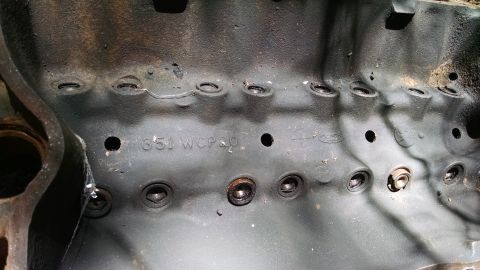 1978 Ford Bronco - Close-up of an engine block casting showing stamped identification numbers.