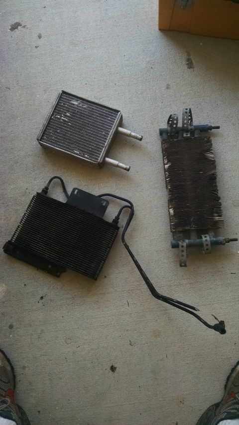 1978 Ford Bronco - Various car radiators and heat exchangers are laid out on a concrete surface.