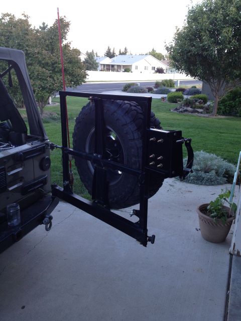 2005 Jeep Wrangler - Rear view of a 2005 Jeep Wrangler showing its tire carrier mount and spare tire.