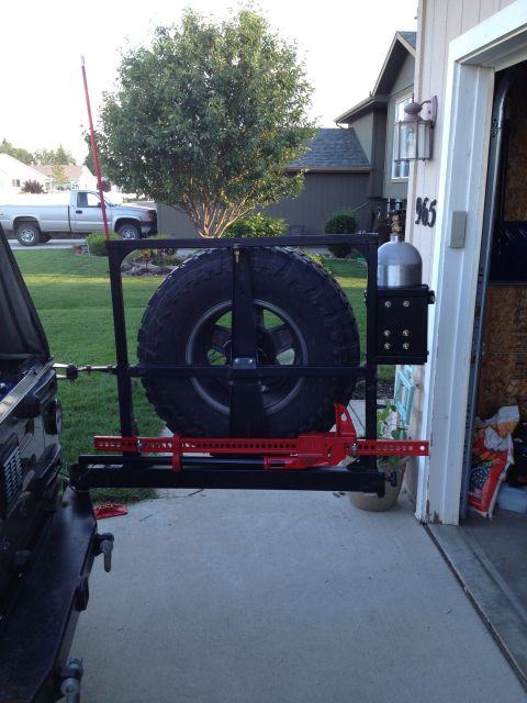 2005 Jeep Wrangler - This Jeep Wrangler features an aftermarket rear tire carrier with a mounted Hi-Lift jack and a propane tank.