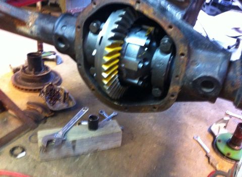Differential gears with yellow teeth, part of a vehicle's drivetrain