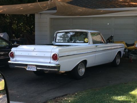 1968 Ford Mustang - A white 1964 Ford Falcon Ranchero pickup truck is parked in front of a garage.