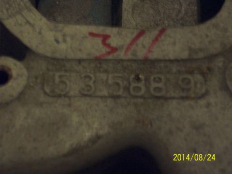 1969 Ford Torino - A close-up shows stamped numbers and red markings on a metal component, possibly a part number.