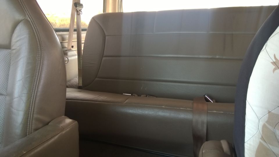 Brown leather seats and seatbelt in a vehicle interior