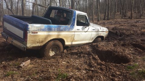 1979 Ford Bronco - This 1979 Ford Bronco is deeply stuck in the mud, with its front end partially submerged in the mire.
