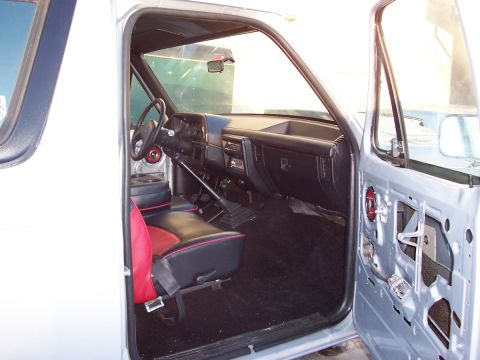 1990 Ford Bronco - Interior view of a 1990 Ford Bronco, custom black and red seats and a manual transmission shifter.