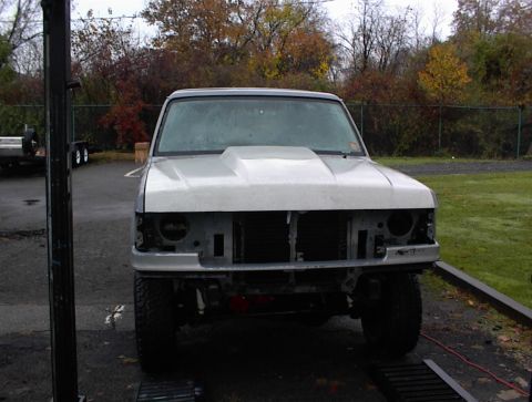 1990 Ford Bronco - This truck is missing its headlights and grille, making it difficult to identify the exact model or year.