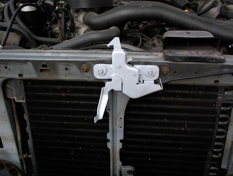 1990 Ford Bronco - Front end of a 1990 Ford Bronco, focusing on the radiator and hood latch assembly.