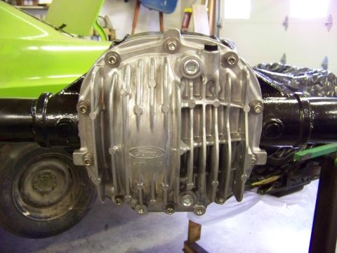 1999 Mercury Grand Marquis - A Ford differential assembly is shown, with a portion of a green vehicle visible behind it.