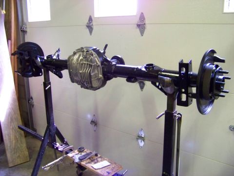 1999 Mercury Grand Marquis - Rear axle assembly, likely undergoing maintenance or rebuild, is displayed on a stand.