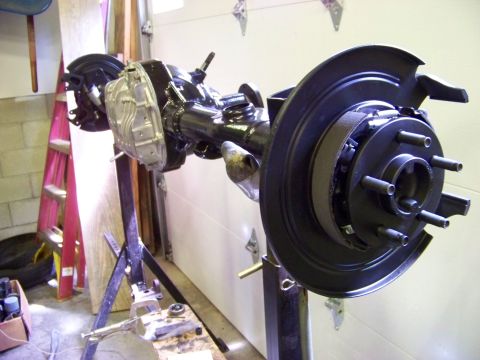 1999 Mercury Grand Marquis - A rear axle assembly, likely from a Ford Panther platform vehicle, is shown on a repair stand.