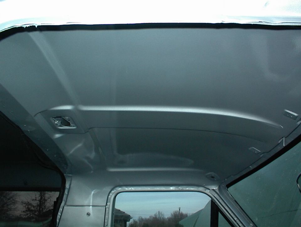 Interior roof of a vehicle, silver paint, showing structural details