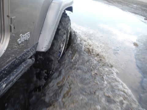 2005 Jeep Wrangler - 2005 Jeep Wrangler driving through a muddy puddle.