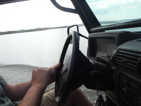2005 Jeep Wrangler - Driving through water from the interior of a vehicle, with hands on the steering wheel.