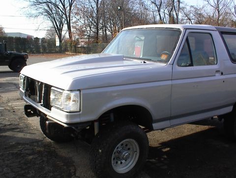 1990 Ford Bronco - This Ford Bronco appears to be from the early 1990s, but the custom hood suggests modifications beyond the original factory design.